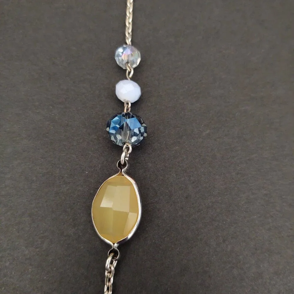 Long silver necklace with blue and yellow glass beads